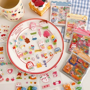 Flat lay of cute cartoon animal stickers including puppies and rabbits for scrapbooking