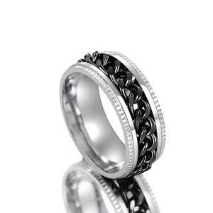 Close-up of a rotatable cuban chain ring with silver and black industrial punk design