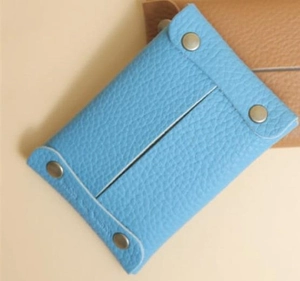 Blue leather tissue pouch with metal snaps and litchi texture for portability