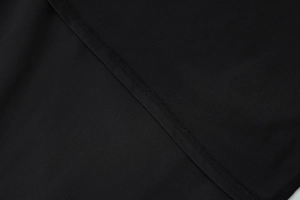 Close-up detail of high-quality flatlock stitching on black summer fashion fabric