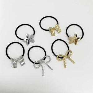 Detailed set of 6 black elastic hair ties with gold and silver metal bow and flower charms