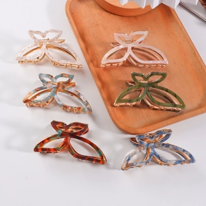 Elegant butterfly acetate hair claws in six marble patterns with gold metal clips
