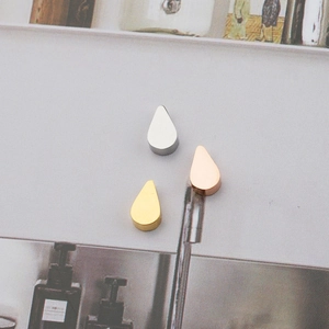 Set of three polished stainless steel water drop pendants in silver, gold, and rose gold