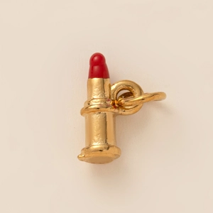 Detailansicht eines vergoldeten Lippenstift-Anhängers mit roter Spitze für Schmuck