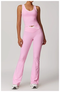 Detail of pink yoga set showing criss-cross high waist flare pants and v-neck sport vest