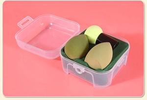Detail of makeup sponge set with teardrop blenders and handle puff in a clear storage box