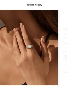 Close-up of a gold S925 silver ring featuring an oval opal stone and small side diamonds