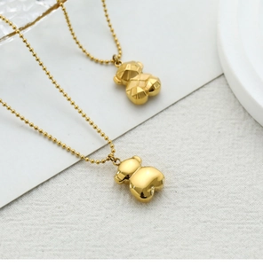 Detailed view of 3D bear pendants with faceted and polished gold-plated finishes