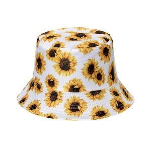 Detail shot of white cotton bucket hat with vibrant yellow sunflower floral prints