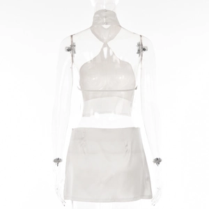 Rear view of white halter neck backless top and mini skirt set on mannequin