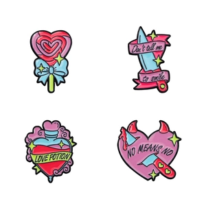Set of four pink cartoon enamel pins featuring lollipop, dagger, and potion designs
