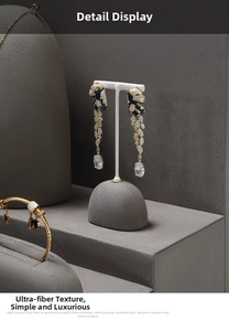 Detail of panther head tassel earring with blue zircons on a luxury jewelry display stand