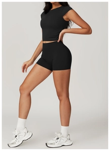 Side view of black slim fit yoga set with high waist shorts and short sleeve top