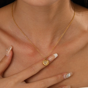 Minimalist 14K gold plated heart pendant necklace with cat-eye stone on female model