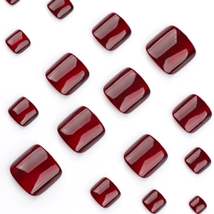 Short square press-on toenails in deep red cat-eye finish with shimmering reflective effect