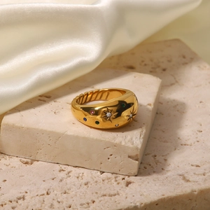 French vintage gold star ring with colorful zircon on a beige stone and white silk