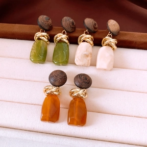 Detailed shot of retro wood and resin geometric earrings in multiple vintage color options