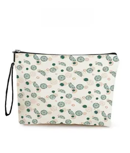 Detailed pattern display of a lime canvas cosmetic bag with black zipper and lanyard