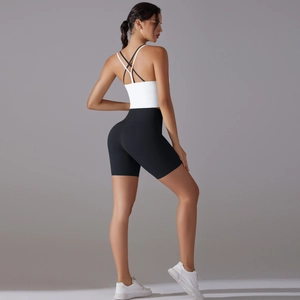 Detail of the cross-back sports bra and high-waist fitness shorts on a model