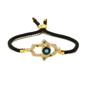 Adjustable black braided rope bracelet with golden Hamsa Hand and Evil Eye charm