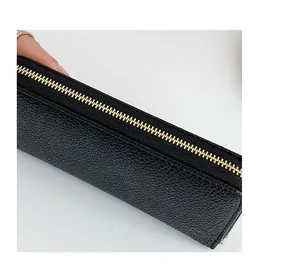 Close-up of premium black litchi texture PU leather wallet with elegant gold metal zipper