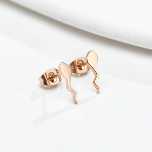 Macro shot of rose gold tadpole stud earrings with a polished metallic finish