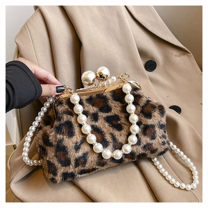 Detail of leopard print faux fur bag with pearl handle and metal clasp closure