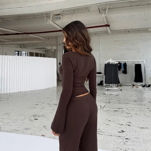 Women's dark brown knit two-piece set with slim-fit long-sleeve top and wide-leg pants