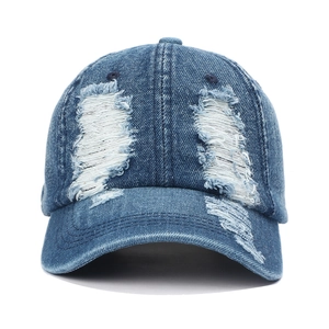 Close-up of distressed denim baseball cap with vintage frayed edges and ripped details