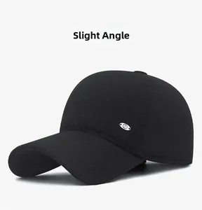 Detailed side view of black winter baseball cap with silver metal logo and warm fabric