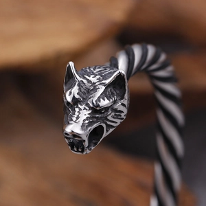 Macro shot of retro silver double wolf head bangle with detailed twisted rope texture
