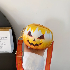 Detail of Halloween pumpkin crossbody bag with jack-o'-lantern face and orange strap