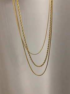 Detailed view of triple-layered 18K gold plated snake and twisted rope chain necklaces