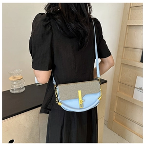 Chic beige fabric and light blue leather crossbody box bag shown on model from behind