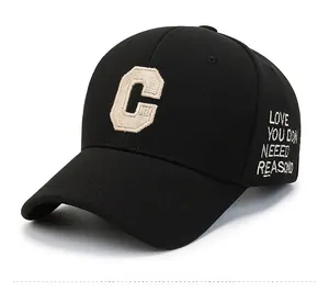 Detail of black baseball cap showing beige towel embroidered C letter and side lettering