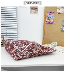 Detailed view of bohemian canvas tote bag featuring ethnic embroidery and tassel zipper