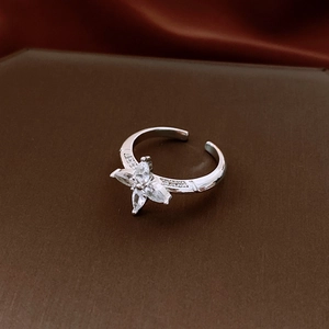 Top-down macro of flower ring with marquise-cut cubic zirconia and silver metal band
