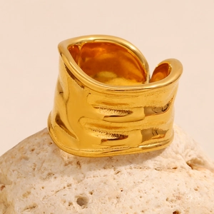Detailed view of wide 18K gold plated ring with irregular textured wavy surface