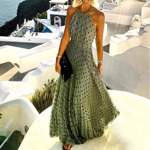 Detail of green halter neck pleated maxi dress with black polka dots for summer