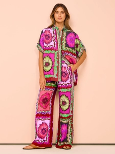 Close-up of bohemian floral print on a summer two-piece shirt and wide-leg trousers set