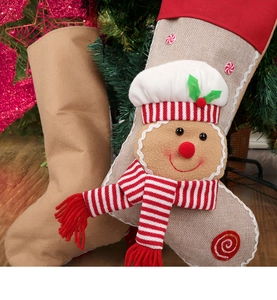 Close-up of burlap Christmas stocking featuring a 3D gingerbread man by the tree