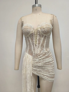 Detail of lace corset dress with fishbone support and asymmetric ruffled hemline