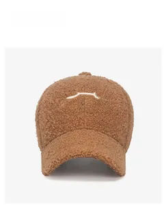 Front view of brown teddy fleece baseball cap with white heart and letter embroidery