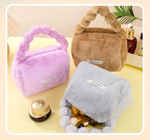 Plush makeup bags in purple, brown and grey showing interior storage capacity on a vanity
