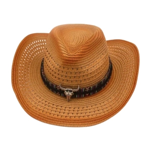 Detail of hand-woven straw cowboy hat with ethnic ribbon and silver bull head ornament