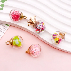 Macro detail of DIY glass bottle pendants with colorful sequins and fruit slice charms