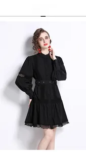 Detailed view of elegant lace hollow-out embroidery on black long-sleeve dress sleeves