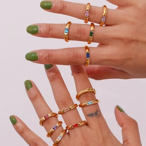 Close-up of stacked 18K gold-plated rings featuring colorful rectangular zircon stones