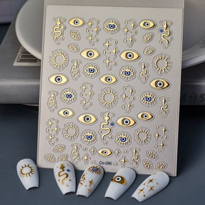 Detailed view of 5D embossed nail stickers with gold evil eye and snake motifs