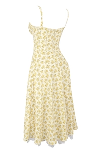 Detail of floral yellow maxi dress with delicate white lace hem and thin straps